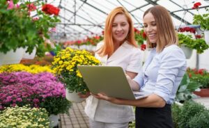 two business women having a conversation while visiting greenhouse